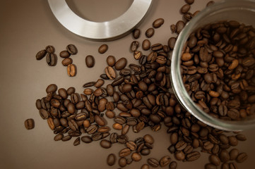 coffee canister lid and coffee beans scattered on the table