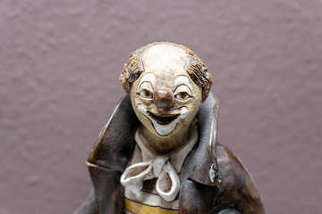 Fototapeta na wymiar Statuette of a clown, ceramic clown figure.