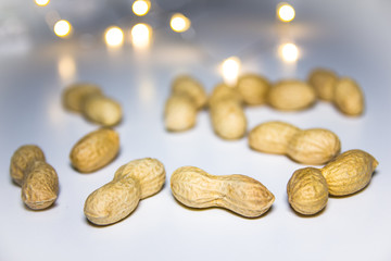 Peanuts on a white background with blurred lights
