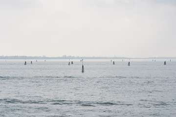 The lagoon of Venice on a rainy and cold day. No people around, no boats around, just sky and water