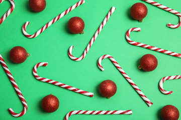 Flat lay composition with Christmas candy canes on color background