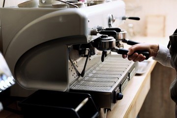 Fototapeta na wymiar Barista preparing coffee using modern machine, closeup