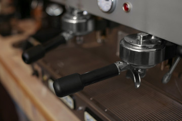 Modern electric coffee machine with portafilter, closeup