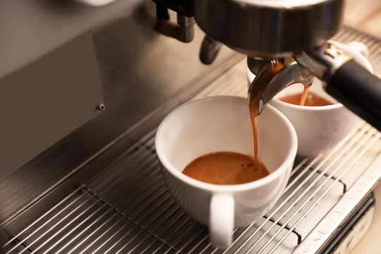 Preparing fresh aromatic coffee using modern machine, closeup. Space for text