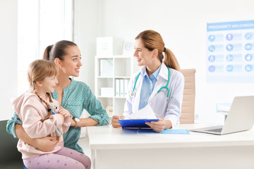 Little girl with parent visiting children's doctor in hospital