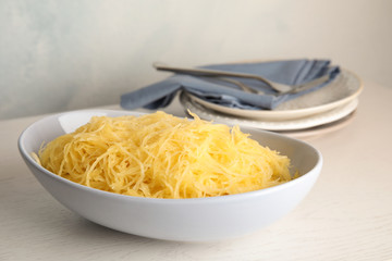 Cooked spaghetti squash in bowl on table