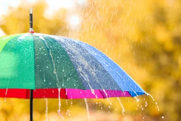 Fotobehang Bright color umbrella under rain outdoors, closeup © New Africa