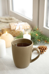 Obraz na płótnie Canvas Composition with cup of hot winter drink near window. Cozy season