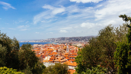 Fototapeta na wymiar Old town of Nice, France between trees, viewed from Castle Hill