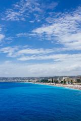 Naklejka na ściany i meble Buildings and beaches next to blue sea in the city of Nice, France