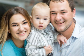 Happy young family celebrating, Closeup portrait of a happy family