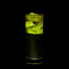 Yellow Sparkling iced alcohol drink with isolated black background