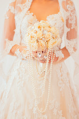 bride with wedding bouquet of flowers