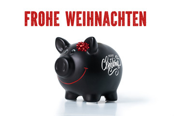 Sparschwein und Weihnachtsgruß isoliert auf weißem Hintergrund
