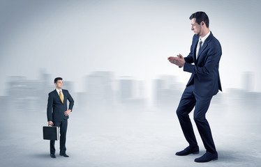 Giant businessman being afraid of small serious executor with suitcase
