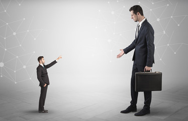 Fototapeta premium Small businessman aiming at a big businessman with connection and network concept 