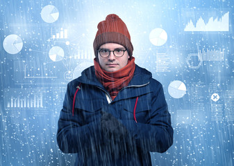 Young businessman shivering with graphs, reports and chart concept

