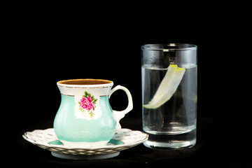 Obraz na płótnie Canvas Turkish coffee and glass of water with isolated black background