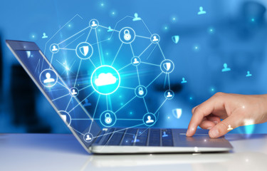 Hand using laptop with centralized cloud computing system and network security concept
