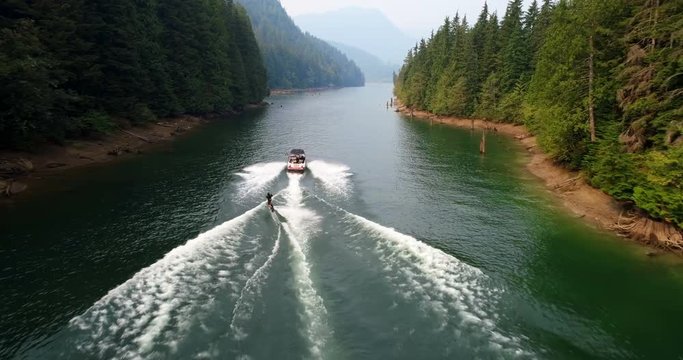 Man wakeboarding with motorboat in the river 4k