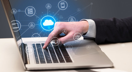 Businessman hand typing with cloud technology system and office symbol concept
