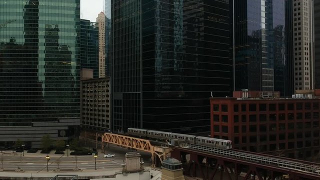 Train passing over bridge entering downtown