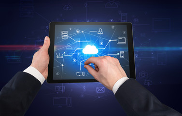 First person view of a hand using tablet with cloud office concept
