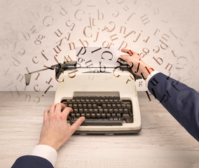 First person perspective elegant hand writing on typewriter with flying letters concept
