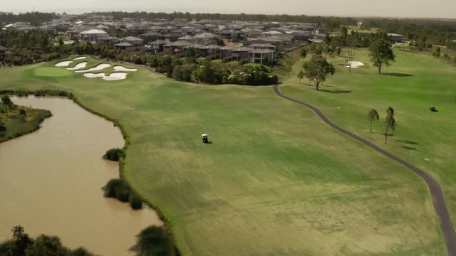 Golfers Driving around the course in Golf Carts