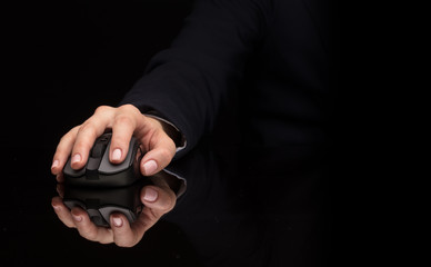 Hand using wireless mouse in a dark environment
