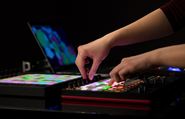 Dj hand remixing music on midi controller
