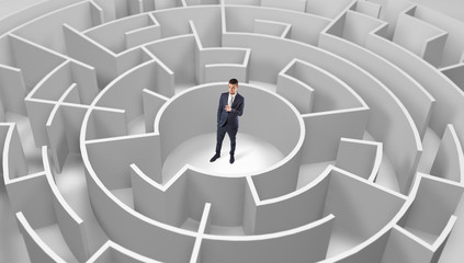 Young businessman standing in a middle of a 3d round maze

