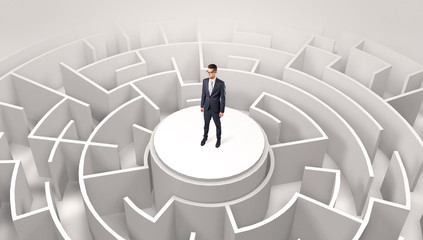 Businessman standing on the top a maze and looking through
