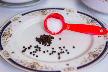 Salt and pepper in a white plate