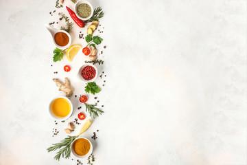 Herbs and spices over light stone background. Top view. Copy space