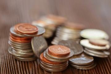 Row of coins on wood background for finance and Saving concept,Investment, Economy, Soft focus and dark style.