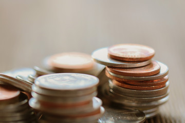 Row of coins on wood background for finance and Saving concept,Investment, Economy, Soft focus and dark style.