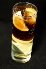 Cuba Libre cocktail with rum, coke and lime juice with lime wedge and full of ices