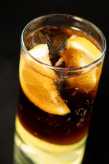 Cuba Libre cocktail with rum, coke and lime juice with lime wedge and full of ices