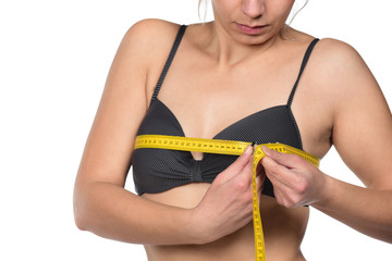 woman measured her breast with a measuring tape