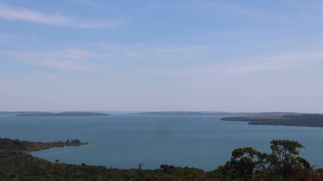 View from hill in Kalangala, Uganda. Time lapse of archipelago (Ssese Islands) in Lake Victoria. Small waves and scattered clouds in blue sky.