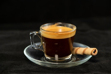 Double espresso and wafer roll with black background