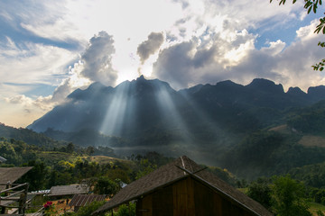 Fototapeta na wymiar Sunlight shines down on the mountain. Through the mist and trees in the morning atChiang Mai, Thailand