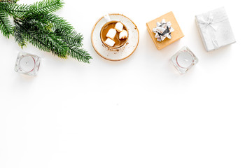 New Year or Christmas concept with hot drink. Cocoa with marshmallow, gift box fir branches on white background top view copy space