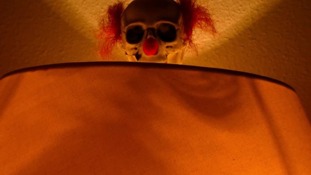 Funny and terrorific Halloween clown skeleton that appears from a lamp