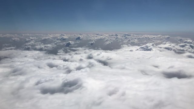 Flying through fluffy white clouds in the sky