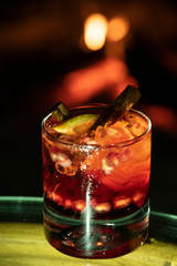 Red cocktail with pomegranate, lemon and alcohol.