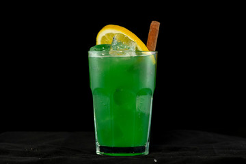 Green Cocktail with green juices, alcohol and lime wedge