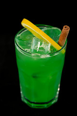 Green Cocktail with green juices, alcohol and lime wedge