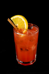 Red Cocktail with red juices, alcohol and lime wedge